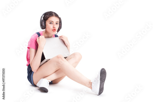 Fototapeta Naklejka Na Ścianę i Meble -  Young woman with headphones listening music on white background