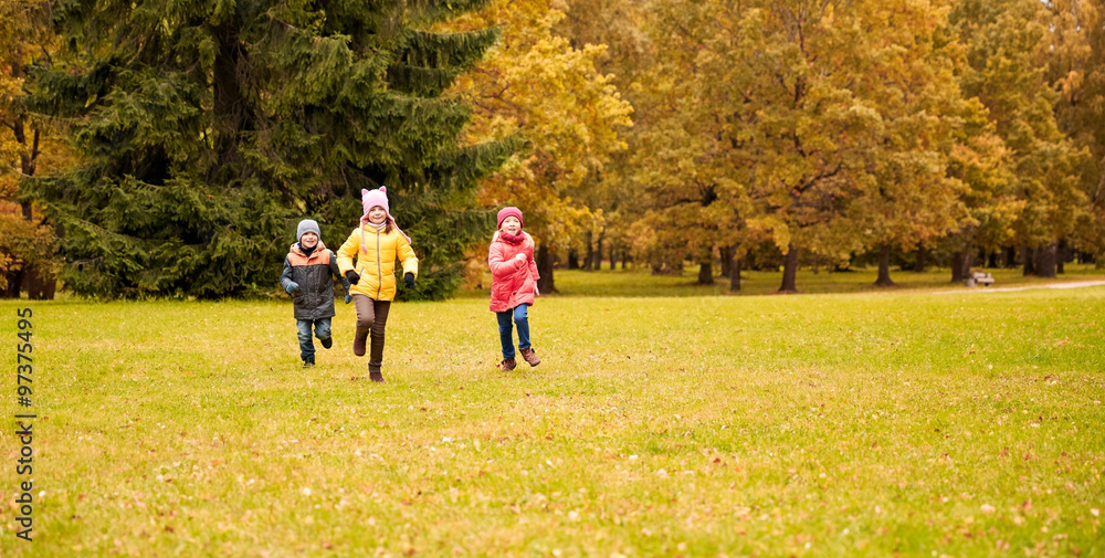 Fototapeta premium group of happy little kids running outdoors