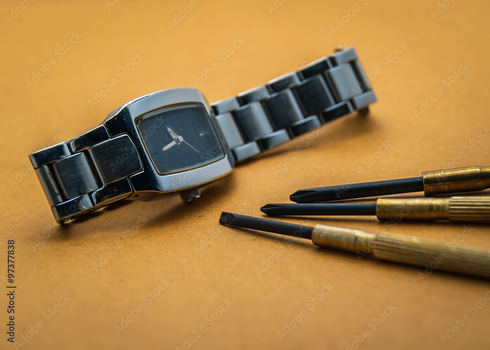 watch repair tools with brown background watch repair tools with brown background