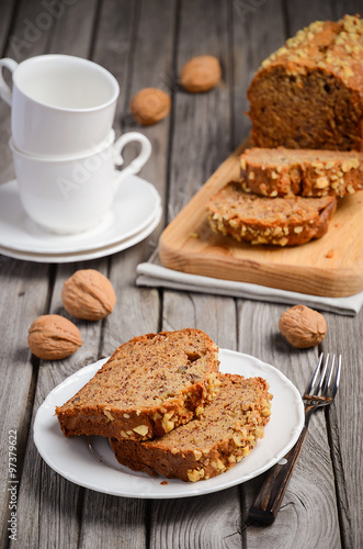 Banana bread with walnuts on the rustic wooden background
