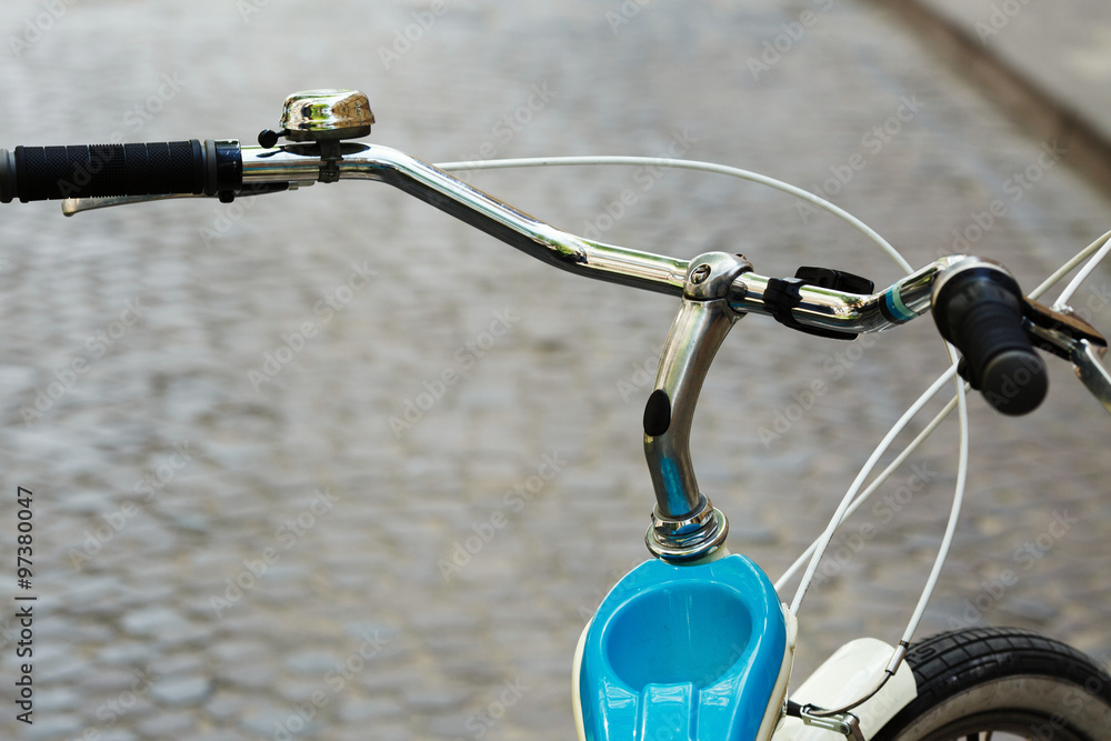 Obraz premium Helm of bicycle which is standing on the street of old city