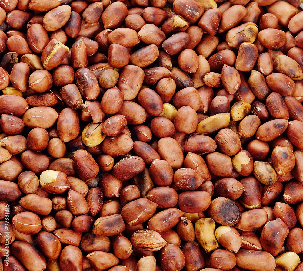 Roasted peanuts in closeup on background. Roasted peanuts in closeup on background.