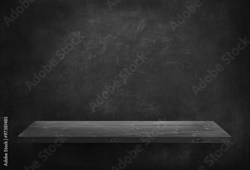 Black wooden plank on dark wall