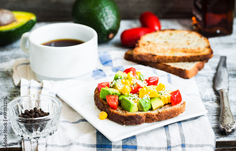 toast with fresh avocado, tomato and corn, a cup of coffee, brea toast with fresh avocado, tomato and corn, a cup of coffee, brea