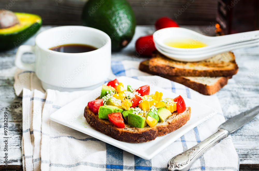toast with fresh avocado, tomato and corn, a cup of coffee, brea toast with fresh avocado, tomato and corn, a cup of coffee, brea