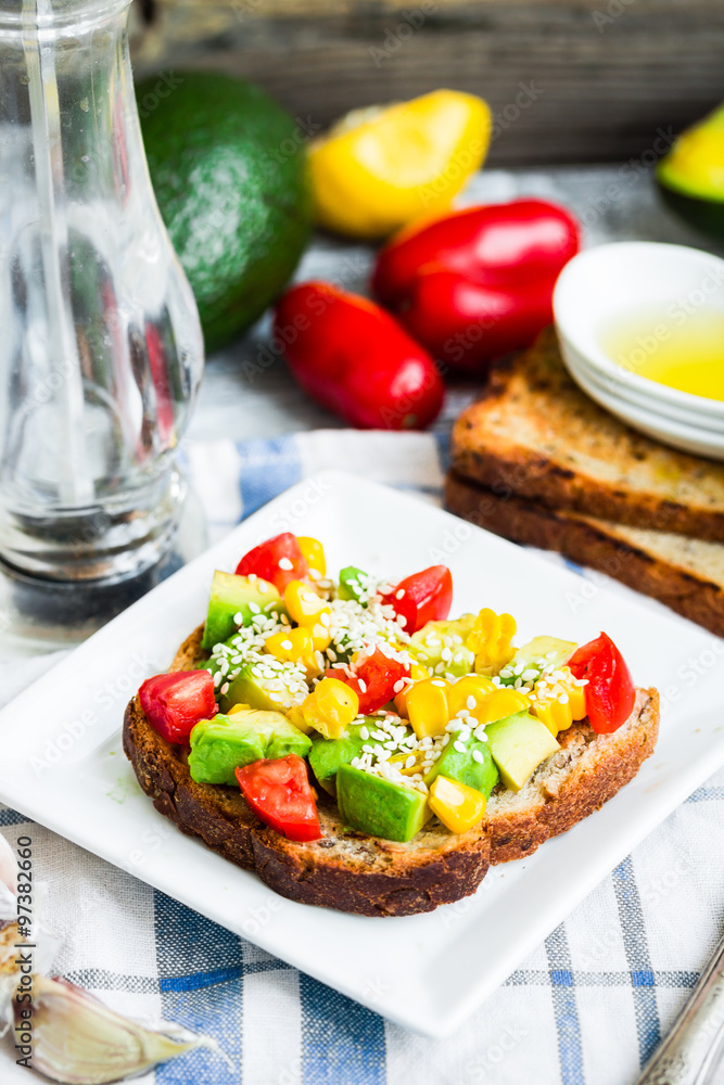 toast with fresh avocado, tomato and corn toast with fresh avocado, tomato and corn