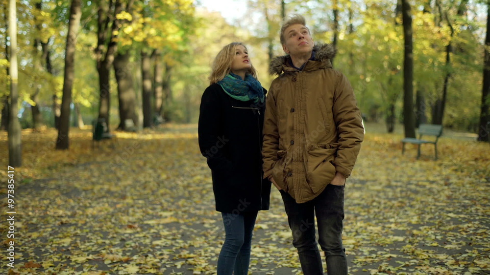 Couple standing in the park and talking with each other
Couple standing in the park and talking with each other