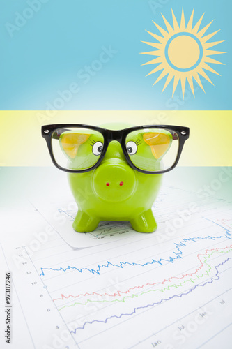 Piggy bank with flag on background - Rwanda photo