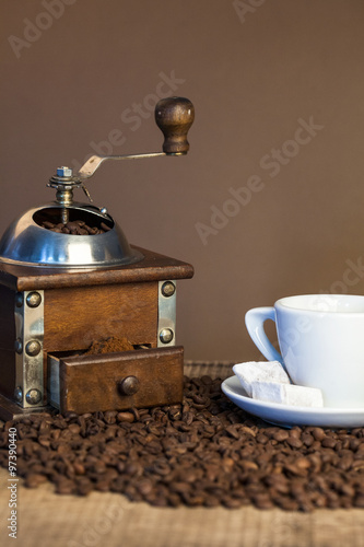 Old coffee mill on dark rustic background