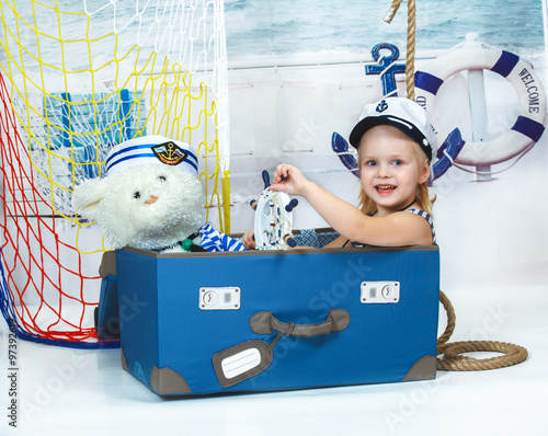 portrait of a beautiful little girl playing, marine theme