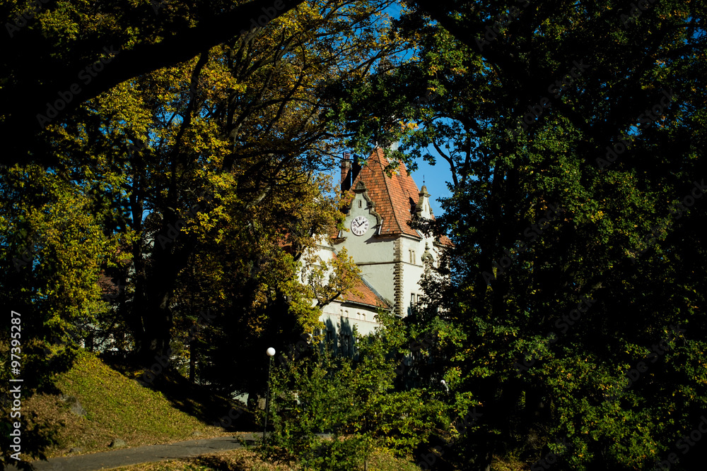 Castle with clock in park Castle with clock in park