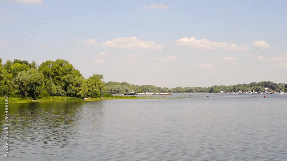 A barge is sailing on the dark waters of the Dnieper river in Kiev, Ukraine A barge is sailing on the dark waters of the Dnieper river in Kiev, Ukraine