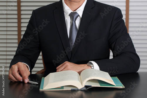 Businessman sitting at meeting room to open the business book