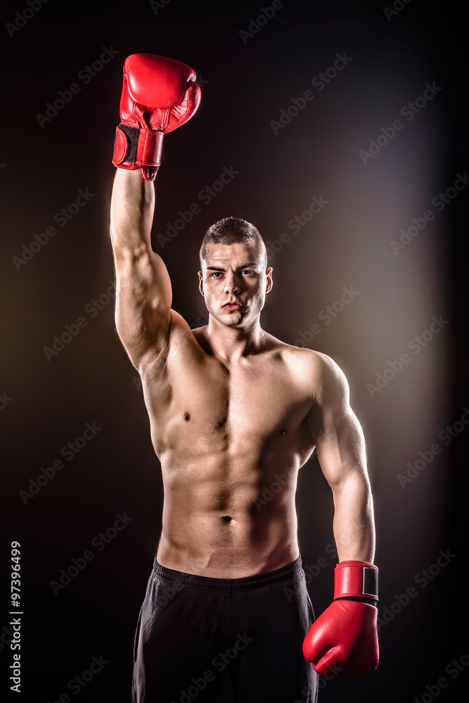 boxer raising both arms after victory