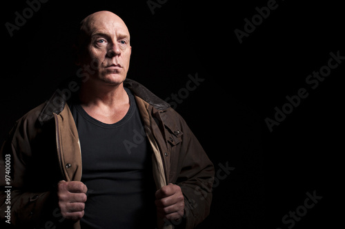 Fotografie Mature male holding his jacket open