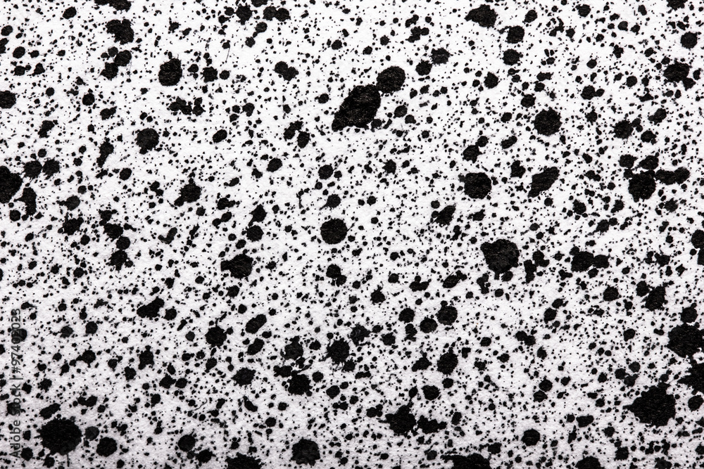 Black ink splashes on white paper texture. Black ink splashes on white paper texture.