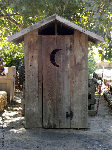Outhouse with crescent moon on door