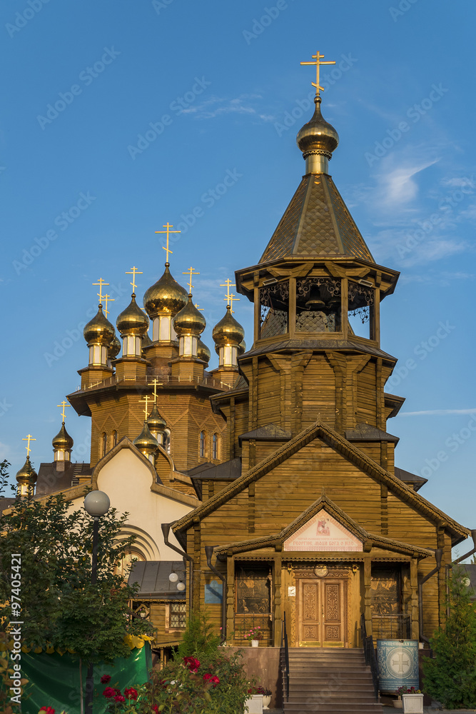 Golden domes of Russian Orthodox wooden church.