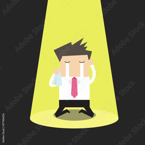 Unlucky businessman crying alone in spotlight