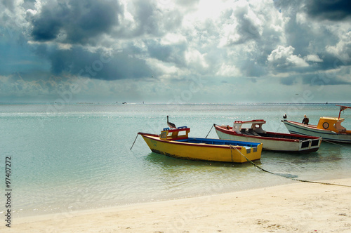 Perfect day at the beach in Aruba, boats on water.