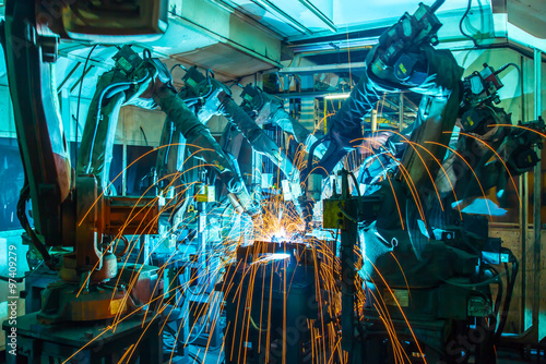 Team Robot welding movement Industrial automotive part in factory