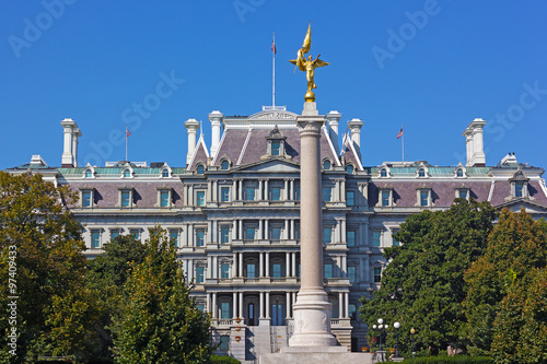 The First Division Monument and The Eisenhower Executive Office Building in Washington DC. The monument on a plaza in President's Park with Old Executive Office Building on background. photo