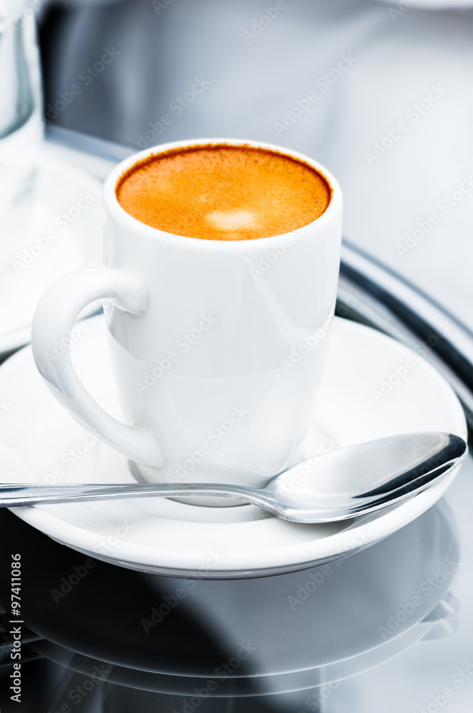 Espresso coffee full cup and saucer by the bed bedside table closeup hotel room service single cup hot drink Espresso coffee full cup and saucer by the bed bedside table closeup hotel room service single cup hot drink