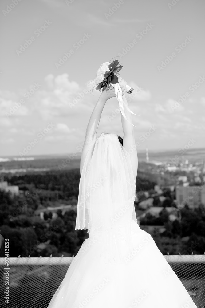 Obraz premium luxury romantic gorgeous holding hands bride and groom on the background of old sunny city