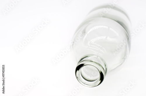 Selective focus at detail of glass bottle on white background. Concept image