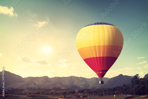 Hot air balloon over mountain  vintage retro filter effect