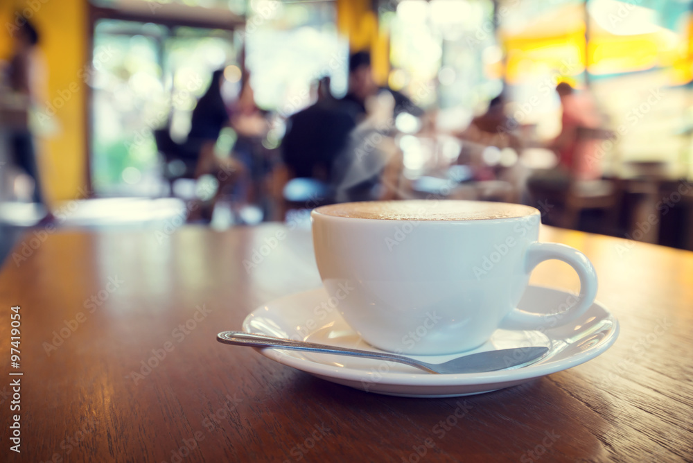Cup of coffee on table in cafe with people - shallow depth of field Cup of coffee on table in cafe with people - shallow depth of field