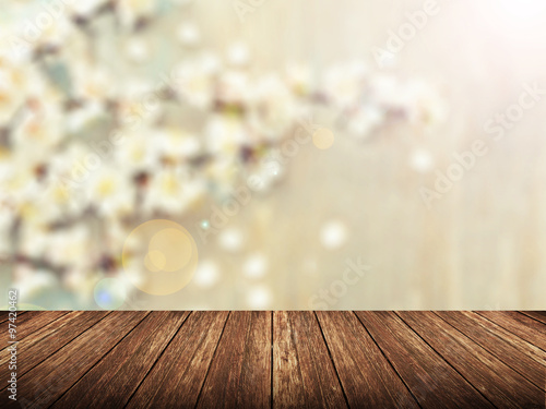 Empty wood table over blurred flower with bokeh background, product display template,deck,