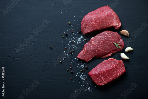 Photography Fresh black angus beefsteaks, black wooden background, copyspace