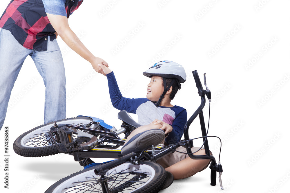 Boy get helps from his dad after falling from bike