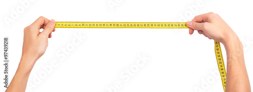 Human hand stretching a measure tape photo