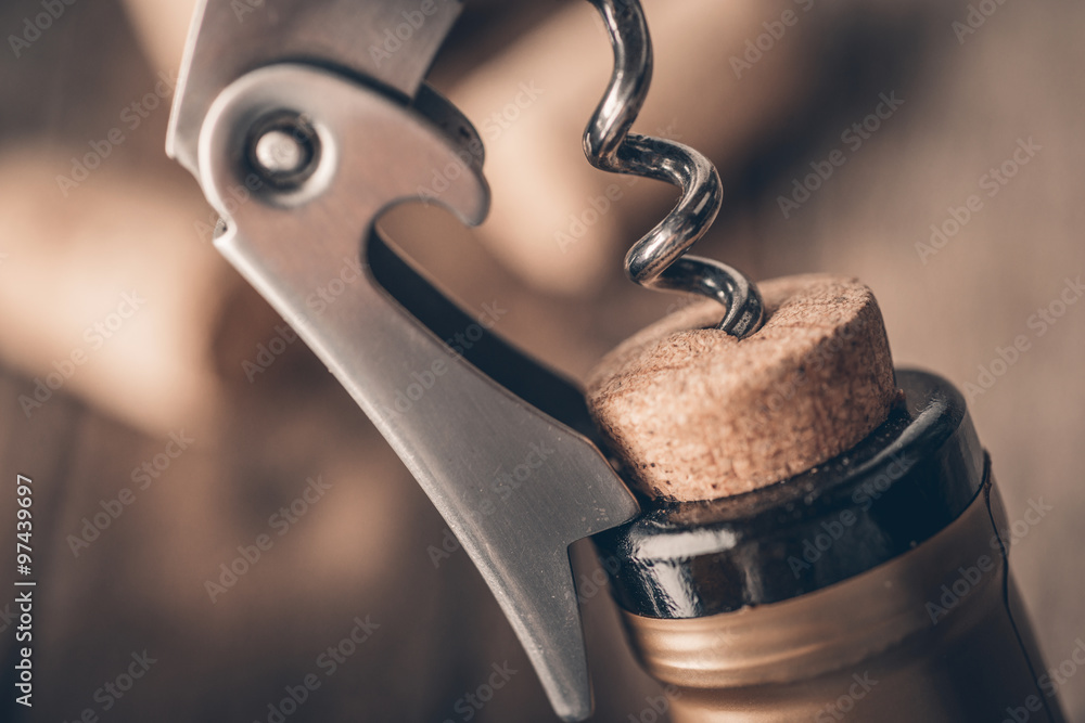 Photo & Art Print Cork screw and wine bottleOpening a wine bottle with a  corkscrew in a restaurant