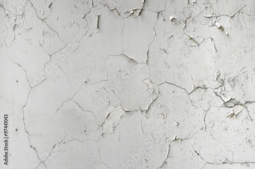 old crack and grunge stucco white wall on vintage house