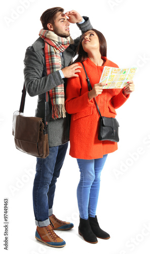 A pair of happy tourists sightseeing in spring/autumn, isolated on white