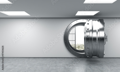 open metal safe in bank depository with money on the floor behin photo