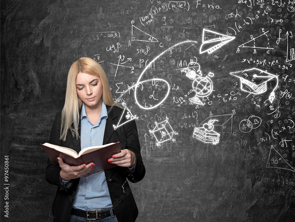 young girl reading blackboard with science icons at the backgrou young girl reading blackboard with science icons at the backgrou