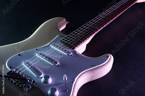 Electric guitar, on dark lighted background