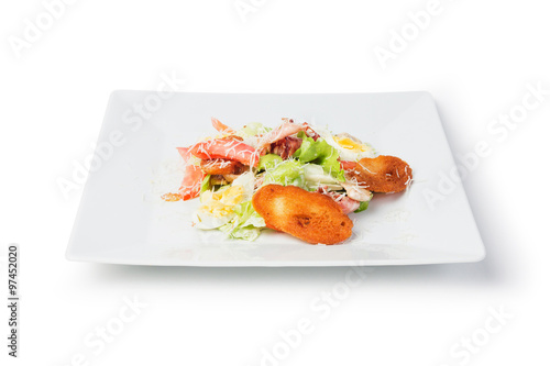 Caesar salad on white plate