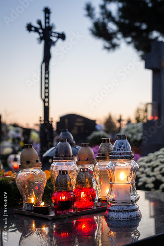 Candles burning at a cemetery during All Saints day. Shallow depth of field.