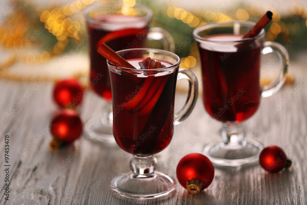 Mulled wine with red Christmas toys on wooden table Mulled wine with red Christmas toys on wooden table