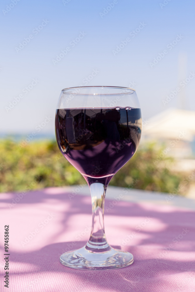 Lonely glass of wine on sunny summer day