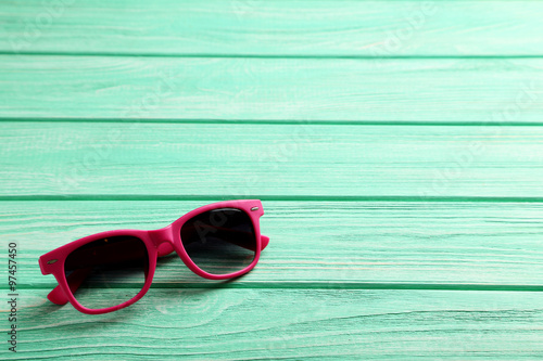Sunglasses on a mint wooden table
