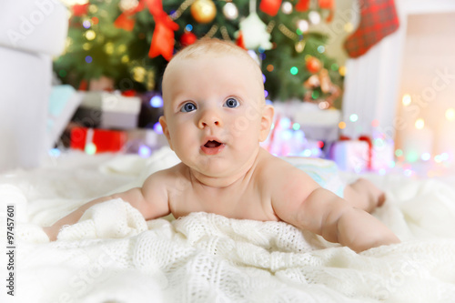Cute baby near fireplace an...