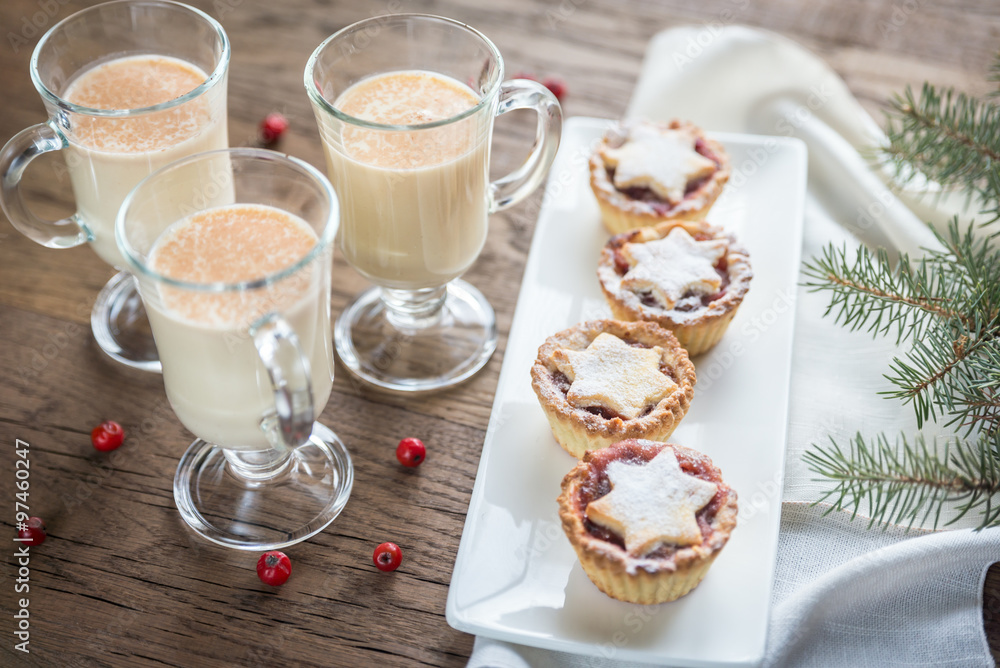 Glasses of eggnog with mince pies Glasses of eggnog with mince pies