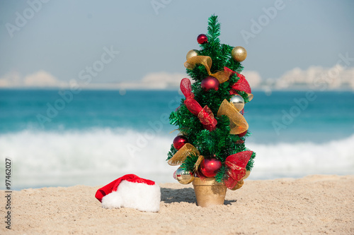 Christmas tree on the beach, a small Christmas tree on the beach, new year in Dubai.
