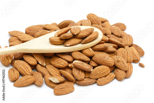 A group of almonds. With a wooden spoon